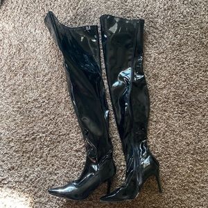 All man made matl, thigh high, solid black boots.